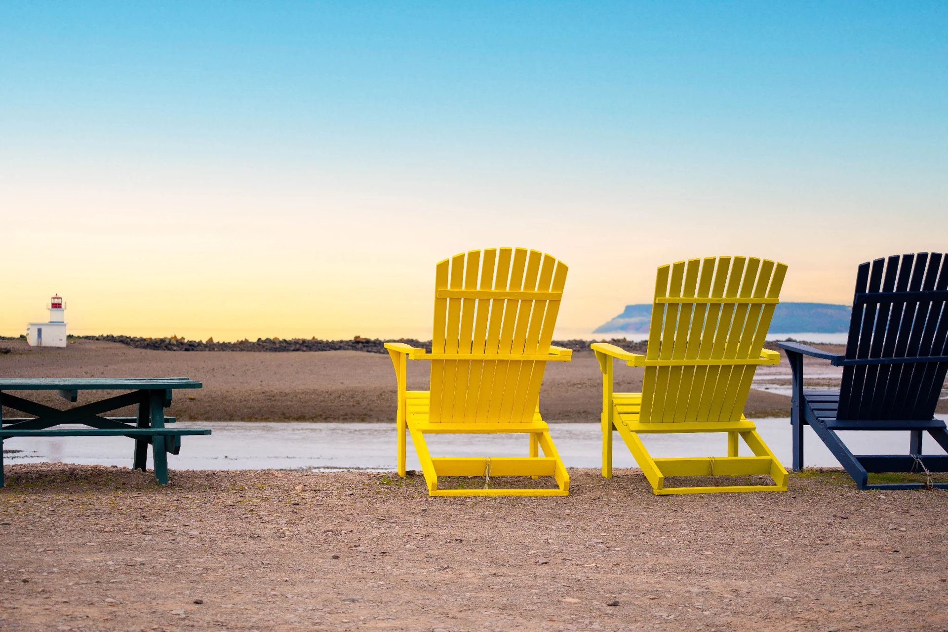 Yellow Adirondack chairs by the Bay of Fundy at sunrise, Parrsboro, Nova Scotia